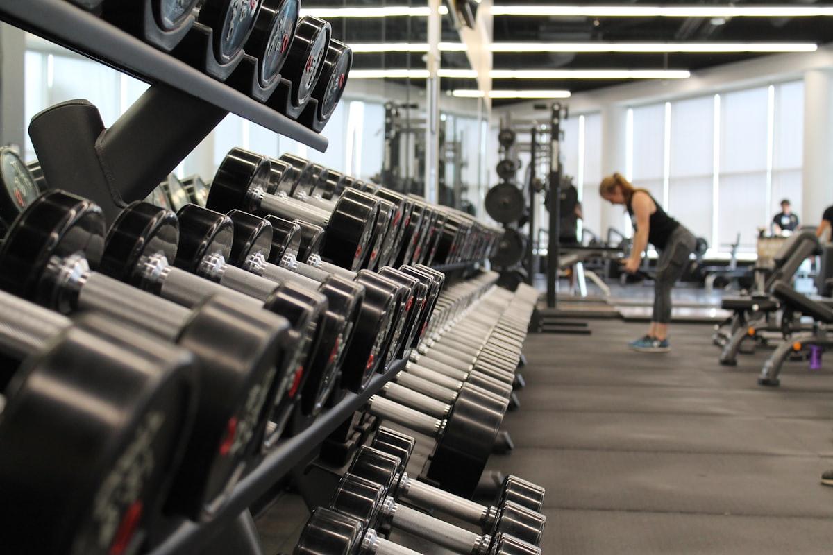 Personal trainer guiding a client through a weights session